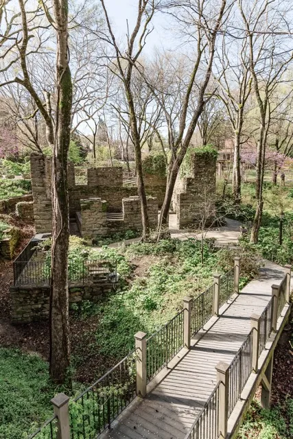 	6.	Winding stone pathway surrounded by lush greenery at The Mill at Fine Creek, leading to scenic outdoor wedding spaces.