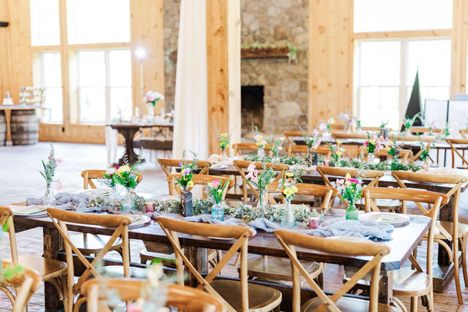 5. Reception tables with greenery and wood decor details