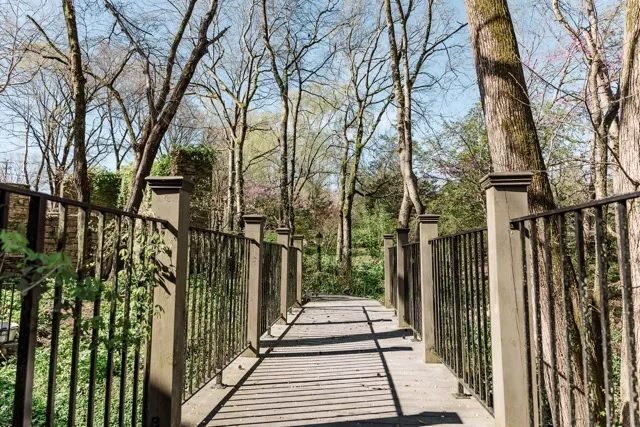 	10.	Scenic wooden bridge surrounded by trees at The Mill at Fine Creek, perfect for wedding photos and intimate moments.