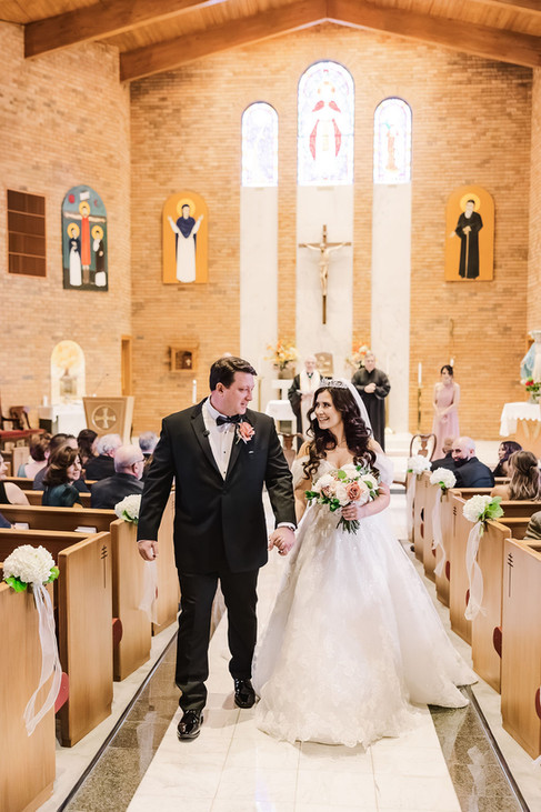 4. Bride and groom walking down the church aisle as newlyweds — joyful Richmond wedding ceremony at The Dominion Club.