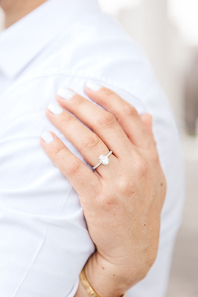 Close-up of engagement ring on bride-to-be’s hand during Capitol session