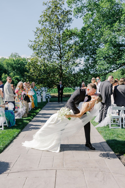 27. Bride and groom first kiss during outdoor Historic Whitewood wedding ceremony