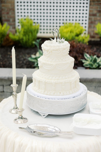 13. Three-tier white wedding cake with candlelit details for a romantic private residence wedding