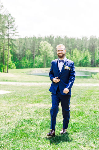 7. Groomsman fixing groom’s tie before ceremony