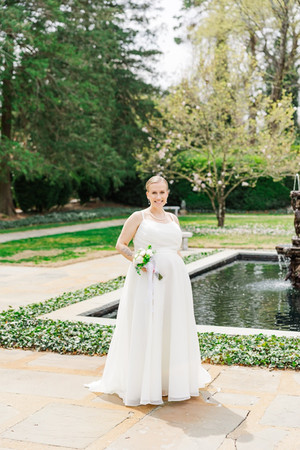	9.	Bride holding bouquet near reflective garden pool