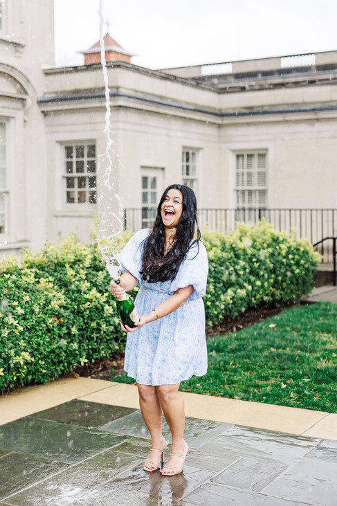 7. Solo senior smiling with champagne bottle at VMFA garden