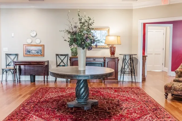 	1.	Elegant lounge area with a vintage-style centerpiece table, warm lighting, and framed artwork at The Mill at Fine Creek.