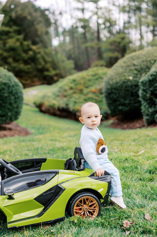 	9.	Baby boy standing by toy car during outdoor milestone session in Richmond VA