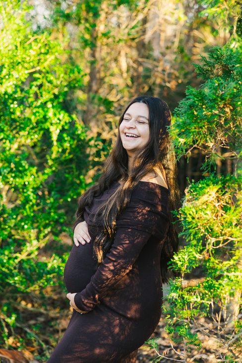 8. Smiling pregnant mom in lace dress surrounded by greenery during Richmond Battlefield maternity photos