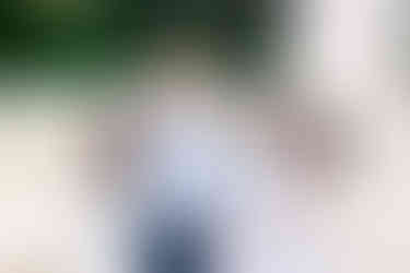 Grandfather smiling and hugging his daughters and granddaughter during their Maymont family session.