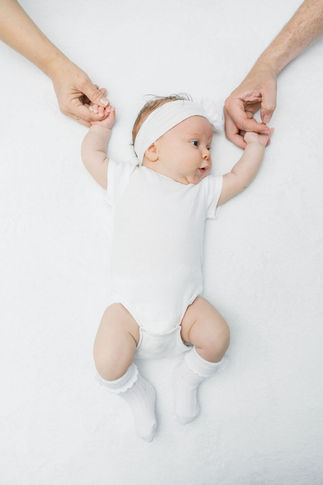 1. Richmond photographer capturing newborn baby stretching during lifestyle session.