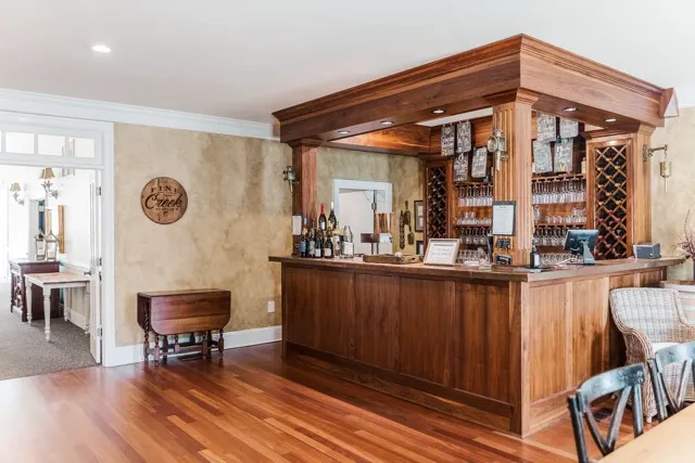 	14.	Warm-toned bar and lounge area with wooden beams and comfortable seating at The Mill at Fine Creek.