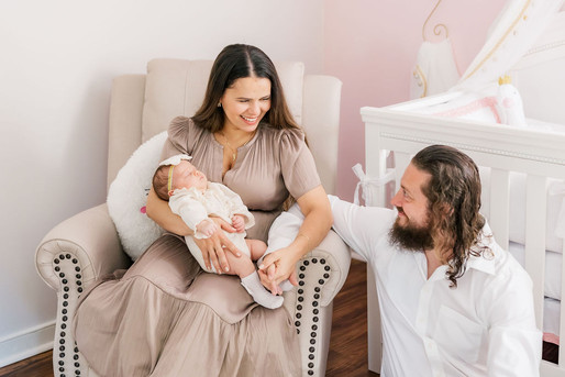 12. Richmond photographer documenting newborn session with parents sitting and smiling.