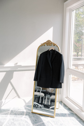 1. Groom’s tuxedo jacket hanging on gold mirror before the wedding — elegant detail captured by Richmond wedding photographer at The Dominion Club.