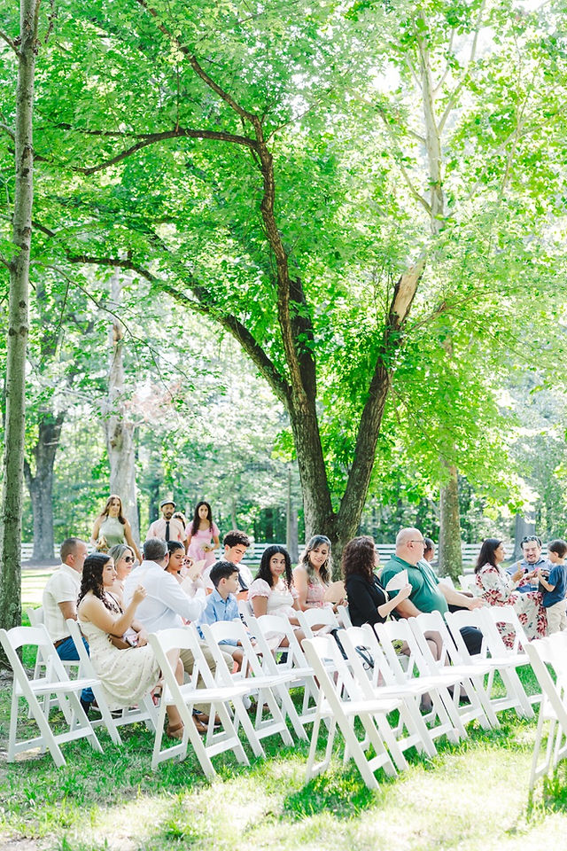 	7.	“Guests seated outdoors for ceremony at The Virginia Cliffe Inn wedding in Virginia”