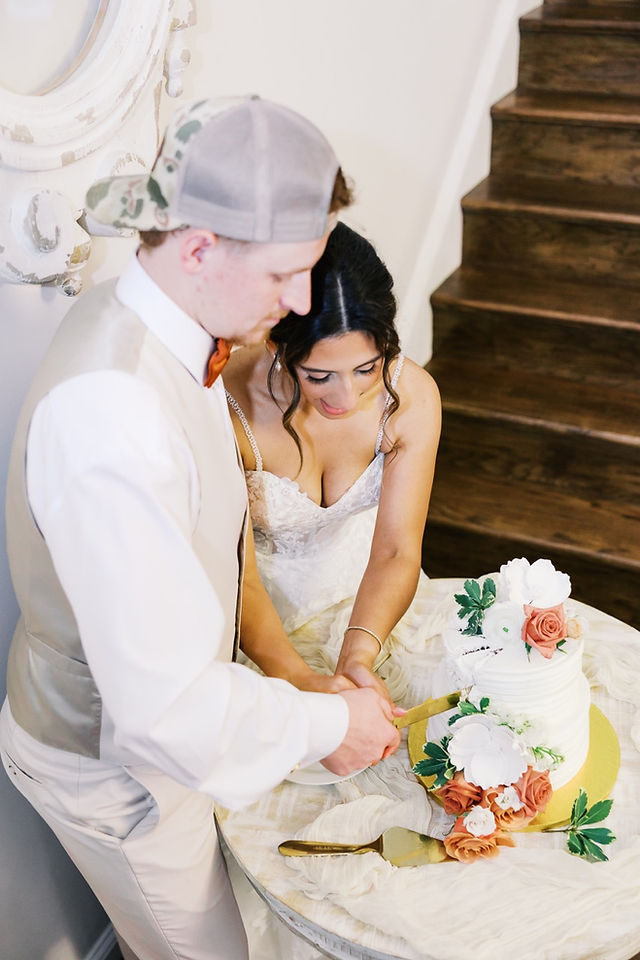 19. Bride and groom cutting wedding cake during Virginia wedding reception