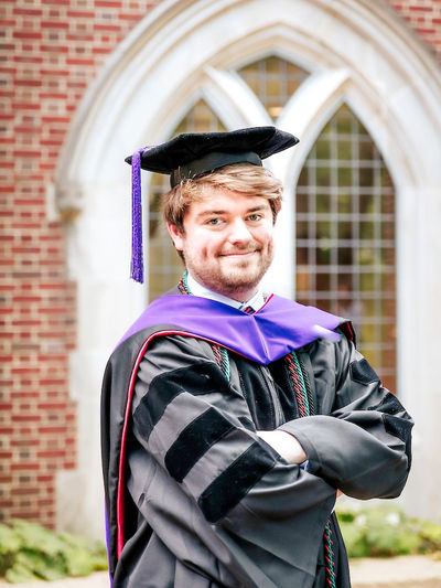 Law school graduate in a purple stole standing at the University of Richmond for headshots with Richmond photographer