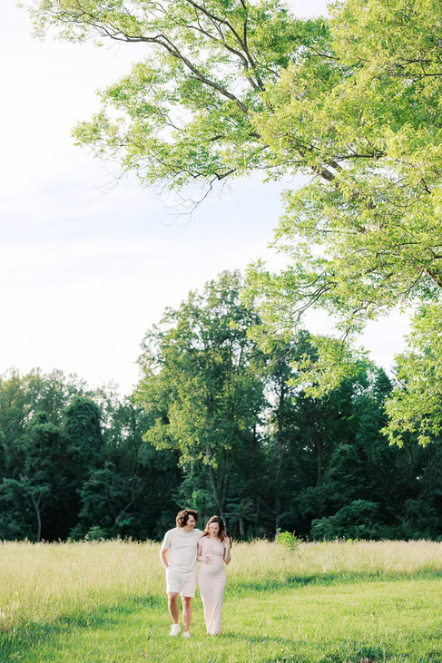 Wide field portrait of Rebecca and Raphael during golden hour maternity photos in Richmond