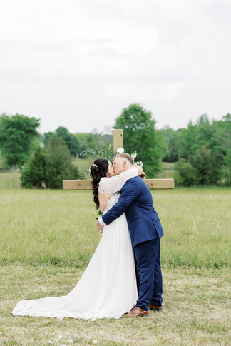 13. Bride and groom first kiss at Virginia countryside wedding ceremony