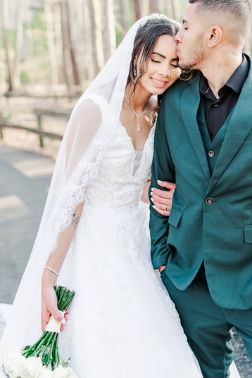 14. Bride resting her head on the groom’s shoulder with soft sunlight filtering through