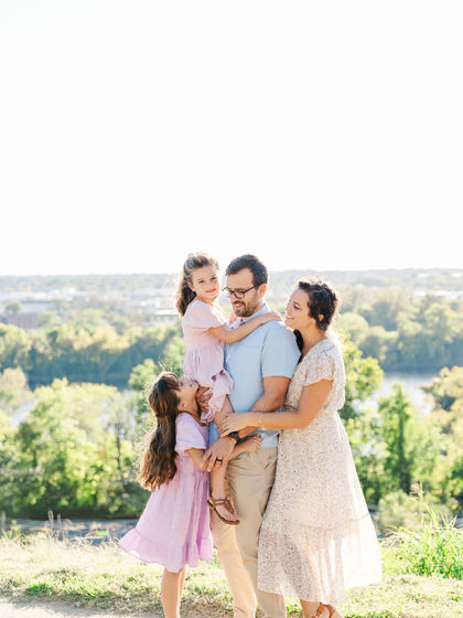 Family hugging during a photo session at Libby Hill Park in Richmond, VA.