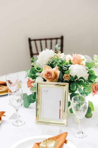 49. Wedding centerpiece with peach and white flowers at Antebellum of New Kent