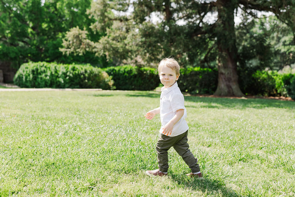 13. Little boy running on grass at Maymont Park
