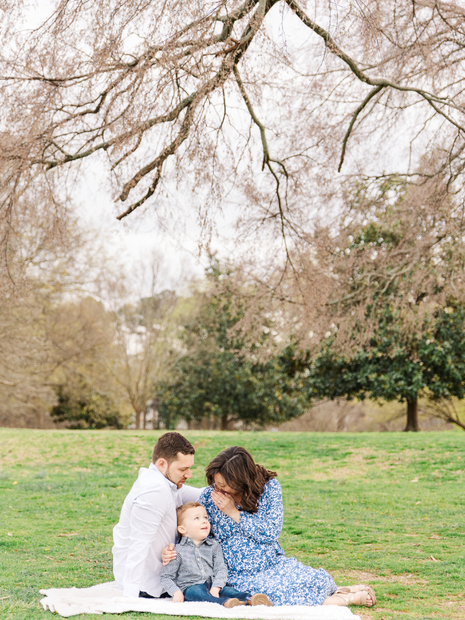 Scenic outdoor maternity session with a mom under a large tree.