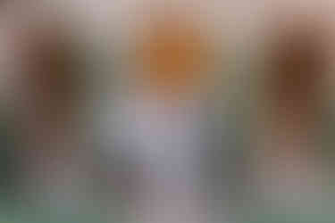 6. Bride and groom standing with two family members, all dressed elegantly.