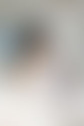 9. Close-up of newborn baby looking toward camera in lifestyle photoshoot