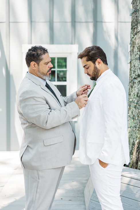 	9.	“Best man adjusting groom’s boutonniere at The Virginia Cliffe Inn wedding”