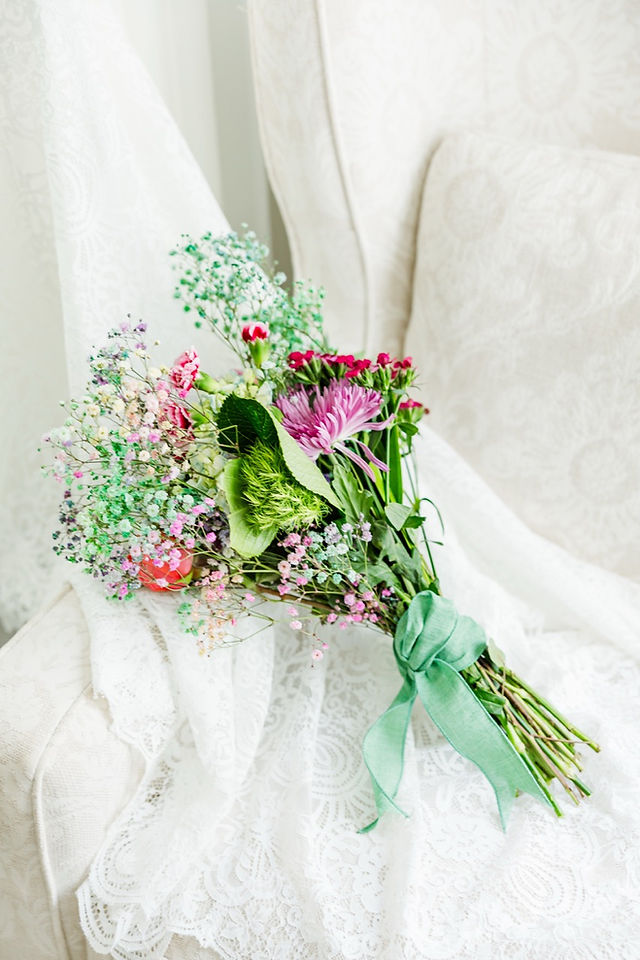 	14.	Pastel wedding bouquet on ivory sofa