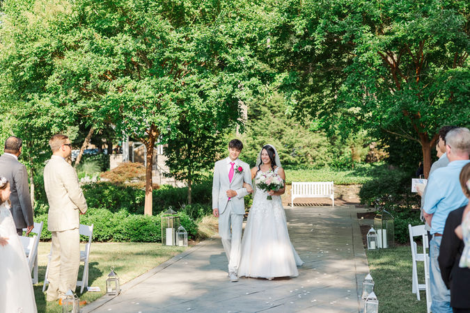 13. Bride walking down the aisle escorted by her father, smiling radiantly.