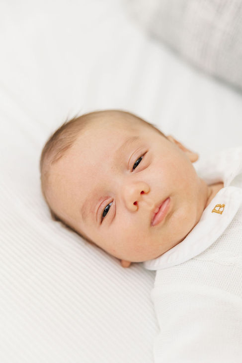 2. Close-up of baby Ben looking at camera in white onesie