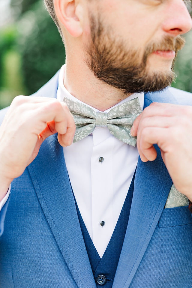 	6.	Close-up of groom adjusting bow tie before ceremony
