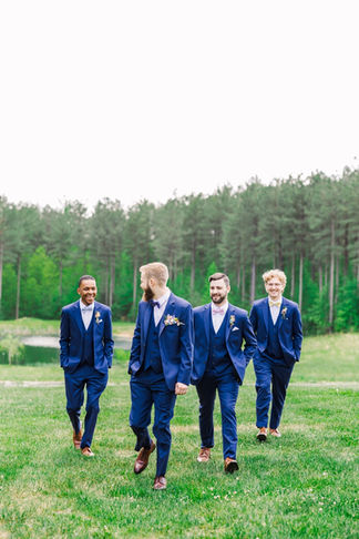 11. Groomsmen walking together outside Timber Creek venue