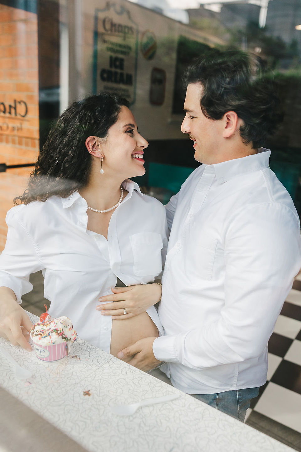 	7.	Husband and wife sharing a sweet moment in retro teal booth during Virginia maternity session