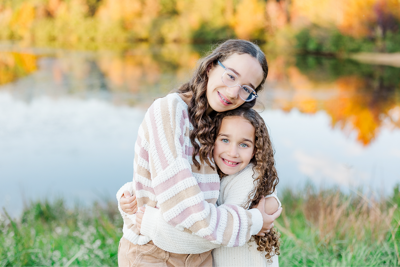sisters hugging each other at the midlothian mines park 2025 fall family mini sessions