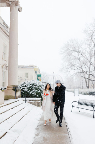 	17.	couple walking in snow after winter wedding ceremony in Richmond VA