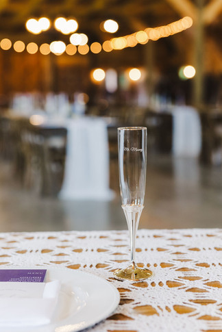 	9.	Close-up of champagne flute at reception table with bokeh lights in background