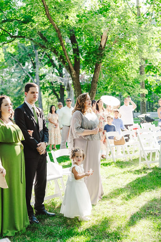 	15.	“Guests watching couple exchange vows during summer Virginia Cliffe Inn wedding ceremony”