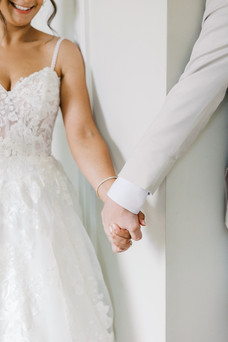 45. Close up of bride and groom holding hands on wedding day