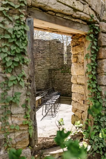 	11.	Sunlit stone courtyard with elegant seating areas nestled within the historic ruins at The Mill at Fine Creek.