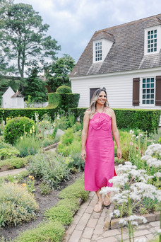 	7.	Woman in pink dress walking through colonial garden