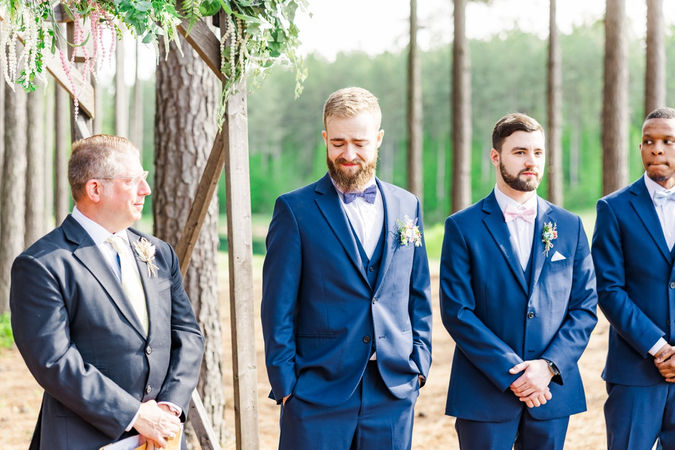 3. Groom smiling as bride walks down the aisle