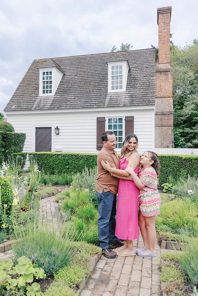 	9.	Couple standing together in front of white historic home