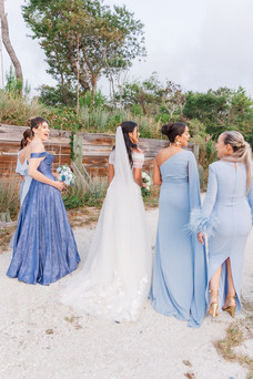 Bridal party wearing mix-and-match dusty blue and lavender dresses during an outdoor wedding.