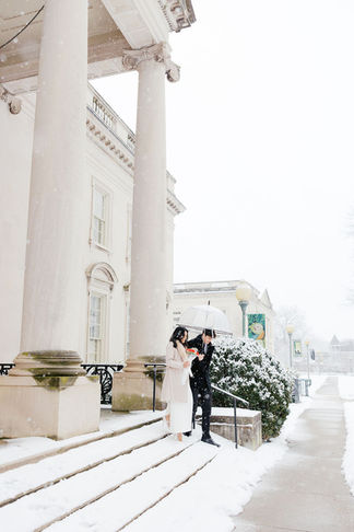 16. bride and groom under grand columns during snowy VMFA wedding