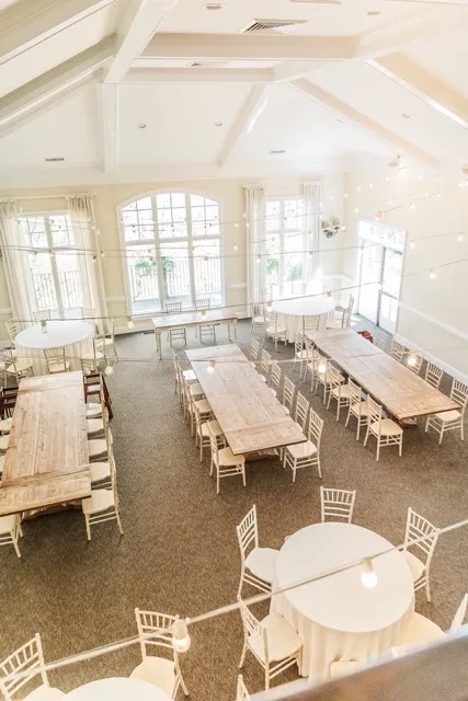 	9.	Long banquet-style wedding reception setup with neutral tones and rustic elegance at The Mill at Fine Creek.