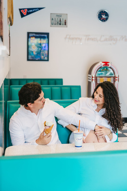 	2.	Couple smiling at each other while sitting in teal booth at Chaps Ice Cream parlor in Charlottesville